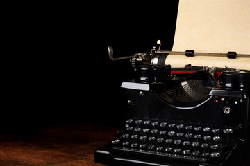 Old vintage typewriter with blank paper