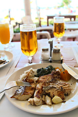 Fried fish with beer in the beach restaurnat, shallow focus