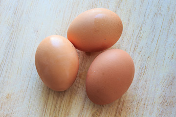 Three Eggs on Wooden Table.