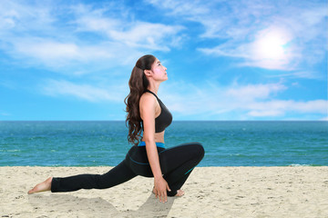 Fototapeta na wymiar woman doing yoga exercise on the beach