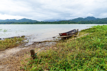 Boat mooring with wooden anchor near river.