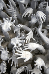 Many hands reaching up to grab.