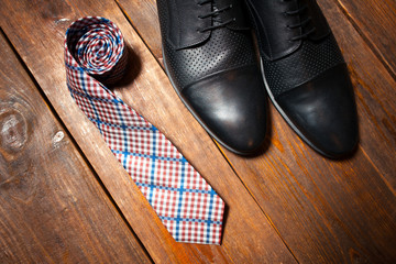  leather footwear and a checkered tie