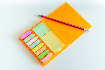 Collection of colorful post it paper note with red pencil.