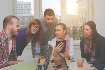 Young group of people discussing business plans.