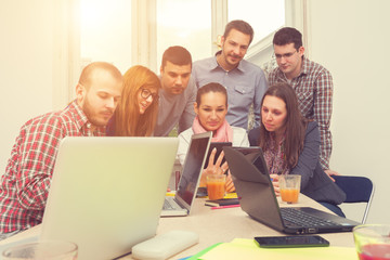 Young group of people discussing business plans.