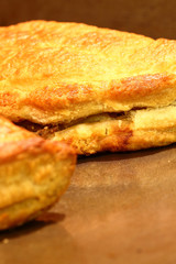 Cornish pasties.
Freshly baked Cornish pasties on a baking tray.
