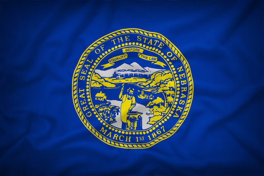 Nebraska flag on the fabric texture background,Vintage style