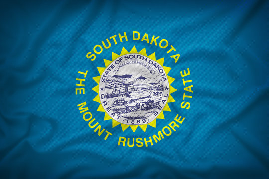 South Dakota flag on the fabric texture background,Vintage style