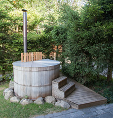 Naklejka premium Wooden hot tub in the alps