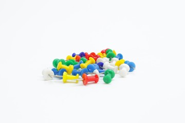 Colorful thumbtacks on white background
