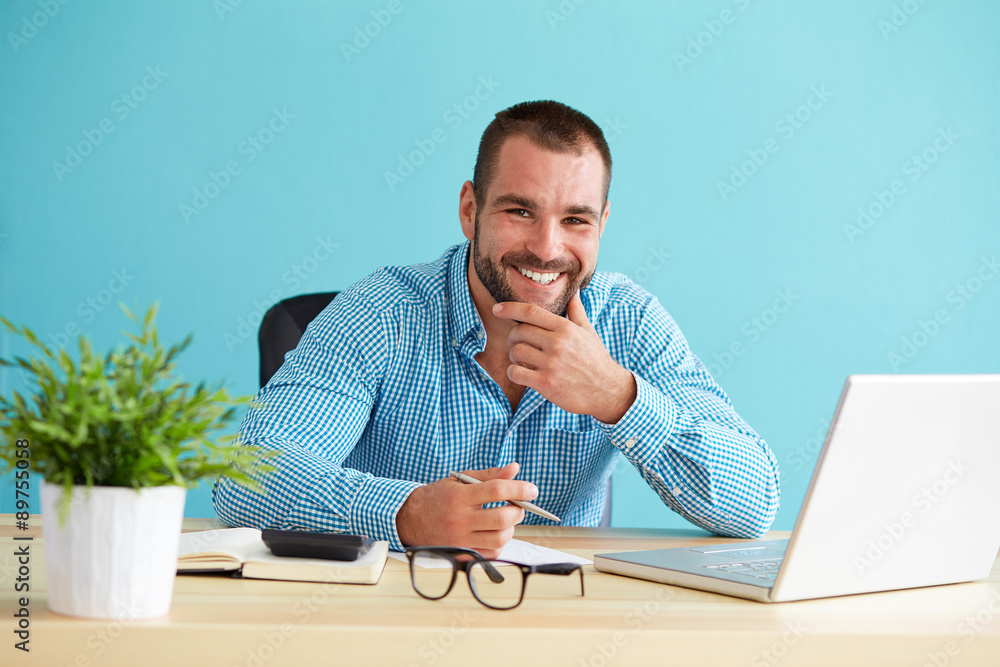 Wall mural Young businessman working