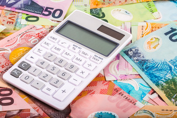 calculator and dollar bills in New Zealand currency