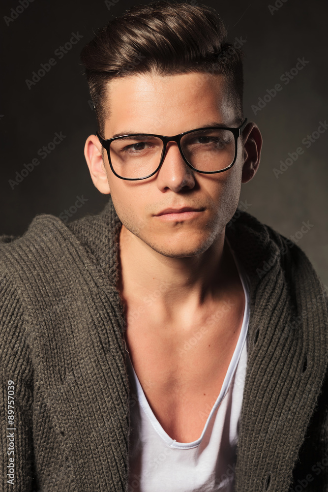 Poster casual young man posing on grey studio background.