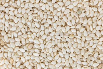 Background of sesame seeds with no shell, viewed from above.