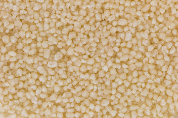 Background of heap of couscous, viewed from above.