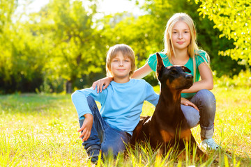 Adorable boy and girl in summer park with their dog - 89758854