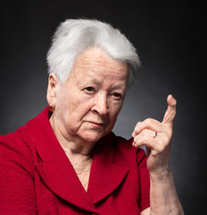 Portrait of old woman in angry gesture