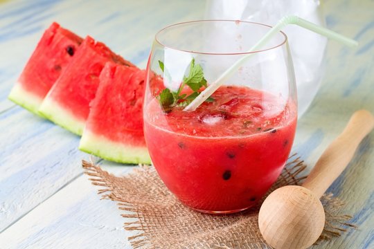 Water melon smoothie in a glass on burlap