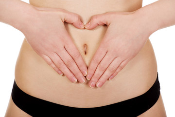 Woman with her hands on belly.