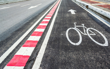asphalt road and bike lane with sign