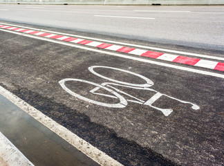Obraz premium asphalt road and bike lane with sign