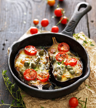 Baked eggplant stuffed with vegetables and mozzarella cheese with addition aromatic herbs. Delicious vegetarian dish