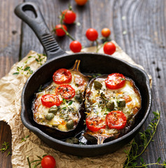 Baked eggplant stuffed with vegetables and mozzarella cheese with addition aromatic herbs. Delicious vegetarian dish