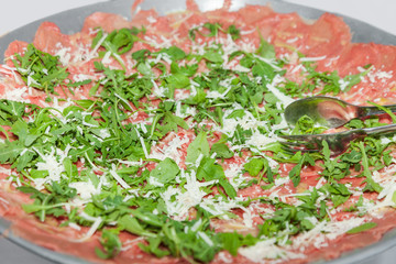 plate of carpaccio with rocket