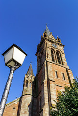 Fototapeta na wymiar Very high belltower of cathedral in Dambach la Ville, France