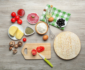 Ingredients for cooking pizza on wooden table, top view