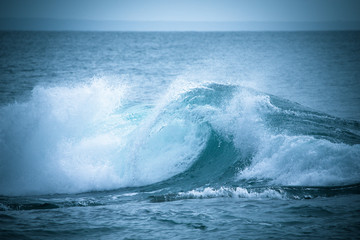 The emerging wave of the sea near the coast.