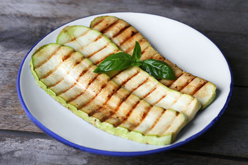 Grilled vegetable mallow in white plate on wooden table, closeup