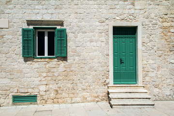 Fototapeta na wymiar Windows and doors on old traditional house in Sibenik, Croatia, facade details