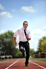 Fototapeta premium businessman running fast on athletic track in work stress and urgency concept