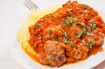 Meatballs in tomato sauce with mashed potato
