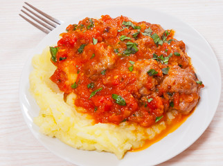 Meatballs in tomato sauce with mashed potato