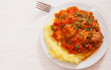 Meatballs in tomato sauce with mashed potato