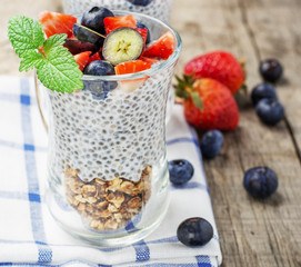 Strawberry, blueberries, oatmeal and chia seeds pudding in a jar for breakfast