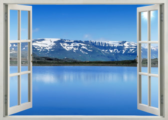 Open window panoramic view to snow mountains and lake