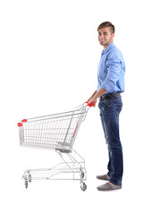 Young man with empty shopping cart, isolated on white