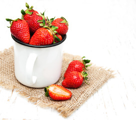 Metal cup with strawberries