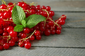 Ripe red currant on wooden background