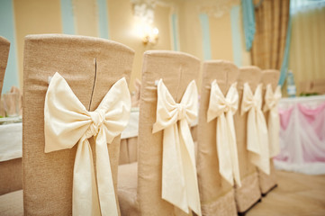 beautifully decorated chairs for the wedding ceremony.