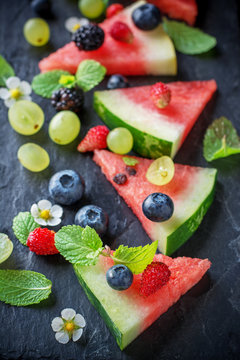 Fruit watermelon pizza with fresh berries and mint