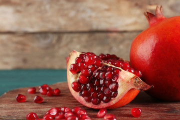 Juicy pomegranate on wooden background