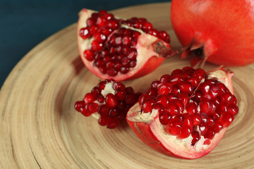 Juicy pomegranate on wooden table, closeup