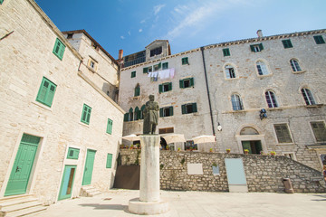 Statue and old traditional houses on public square in Sibenik, Croatia