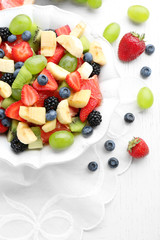 Fresh fruit salad on white wooden table
