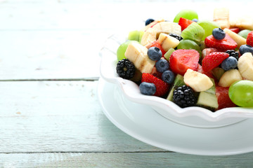 Fresh fruit salad on wooden table